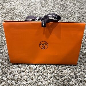 Hermès Vibrant Orange Bag with Black Ribbon